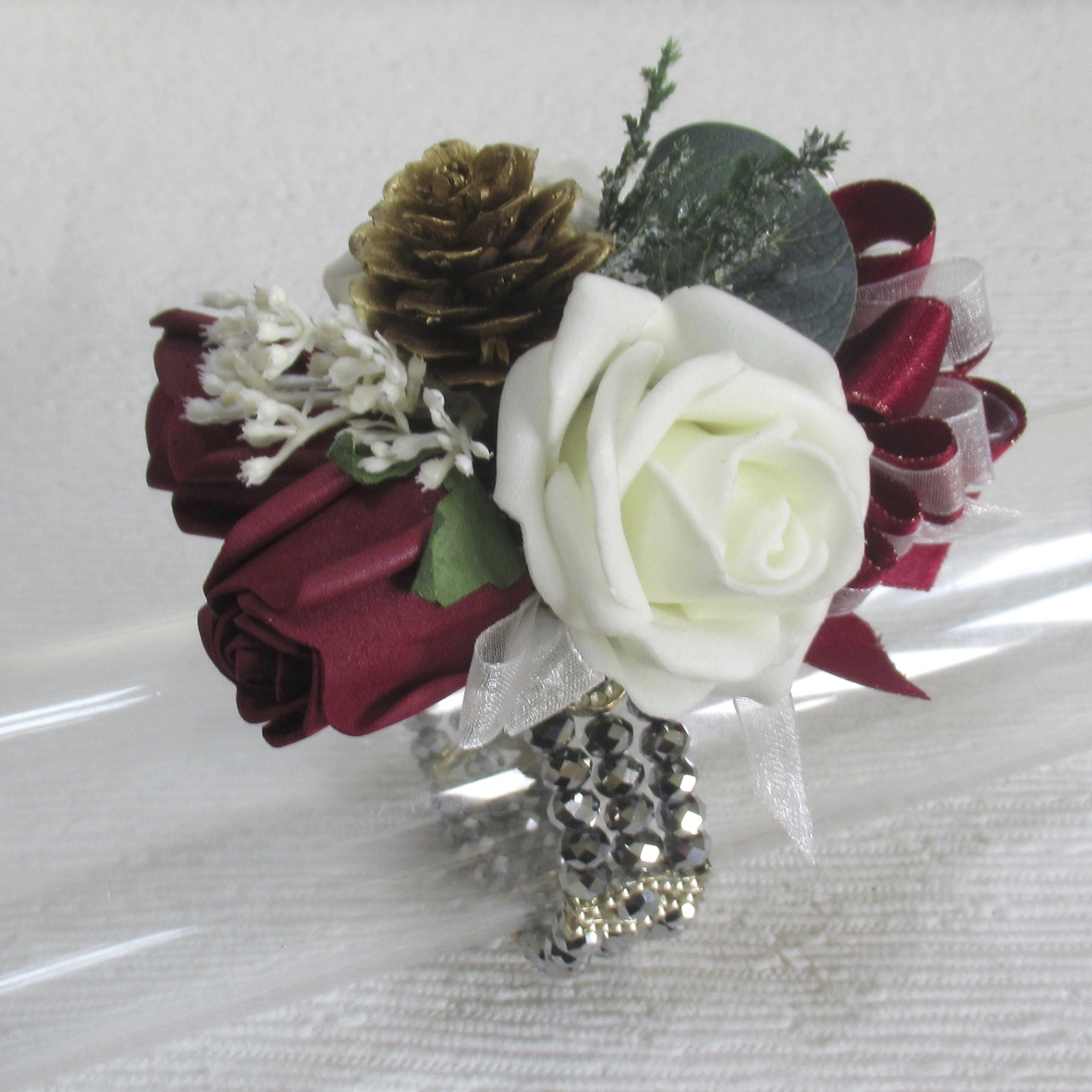 Burgundy & ivory wrist corsage with pine cone, christmas wedding